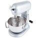 A KitchenAid stand mixer with a bowl and a KitchenAid 11-wire whisk attachment.