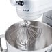 A KitchenAid stand mixer with a wire whisk attachment inside.