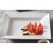 A CAC Princesquare white porcelain pasta bowl filled with watermelon slices.