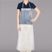 A woman wearing a clear vinyl apron.