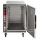 A large metal Metro heated holding cabinet with a door open.