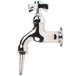 A silver T&S lab faucet with a green knob.