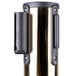 A brass metal cylinder with a black metal tube inside.