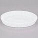 a white round dish on a gray background