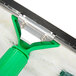 A Unger Visa Versa window cleaner with a green handle.