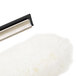 A close-up of the Unger Visa Versa window squeegee with a white fluffy brush and black handle.