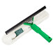 An Unger Visa Versa window squeegee with a green handle.