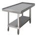 An Advance Tabco stainless steel equipment stand with a galvanized shelf.