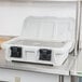 A speckled gray Cambro food pan carrier on a stainless steel counter.