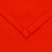 A close up of an orange fabric with a white hem.