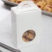 A white candy box with a circular window.