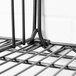 A close up of a black Metro wire shelf with a wire shelf divider.