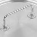 A Vollrath stainless steel pot cover with loop handle on a metal surface.
