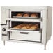 Bakers Pride countertop oven with trays of pastries baking.