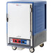 A blue and silver Metro C5 holding and proofing cabinet with wheels.