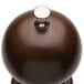 A close-up of the silver knob on a Chef Specialties President walnut pepper mill.