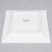 A white square Arcoroc porcelain plate.