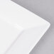A white porcelain square plate with a white rim.
