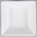 An Arcoroc white square bowl with a flared edge on a gray surface.