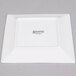 A white square Arcoroc porcelain plate with black text that says "Arcoroc"