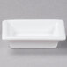 A white rectangular dish with small rectangular bowls.