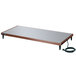 A rectangular metal surface with a cord.