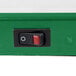 A close up of a green and red switch on a white background.