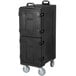 A black plastic Carlisle Cateraide food pan carrier with wheels.
