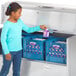 A girl opening a Traulsen school milk cooler.