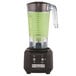 A Hamilton Beach Rio Bar Blender with green liquid in it.