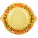 a yellow plate with a floral design