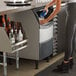 A woman pouring water into a Scotsman undercounter ice machine.