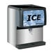 A Scotsman countertop ice dispenser machine with a black and silver surface.