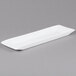 A white rectangular porcelain platter with a long edge.