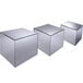 A group of Cal-Mil glass cubes with mirror surfaces on a table.