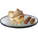 A Cal-Mil mirror tray with bread and crackers on it.