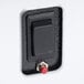 A close-up of a black switch with a red button on a white background.