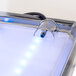 A close up of a Cal-Mil ice carving mirror pedestal with blue LED lighting.