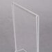 A clear plastic stand on a gray surface with a white card in it.