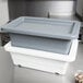 A grey Winholt WHPL-8GY plastic lug on a counter.