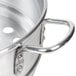 An aluminum steamer pot with handles.