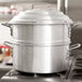 A Town aluminum water pan in a large silver pot on a stove.