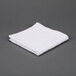 A folded white Oxford Bronze wash cloth.