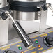 A close-up of a black handle for a Carnival King Waffle Cone Maker.