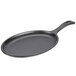 A black oval Lodge cast iron fajita skillet with a handle.
