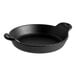 A Lodge black cast iron round casserole dish with handles.