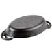 A black cast iron oval casserole dish with a handle.