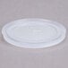 A white plastic lid with a straw slot and a cross on it.