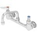 A chrome T&S wall mount pantry faucet with two blue handles.