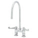 A chrome Equip by T&amp;S deck mount faucet with wrist action handles and a swing nozzle.